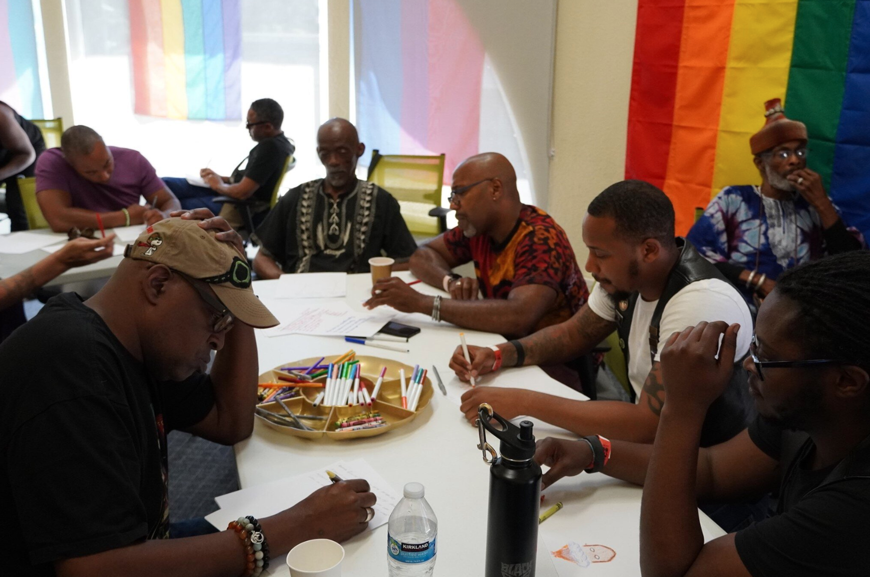 Group of black males sitting around a table